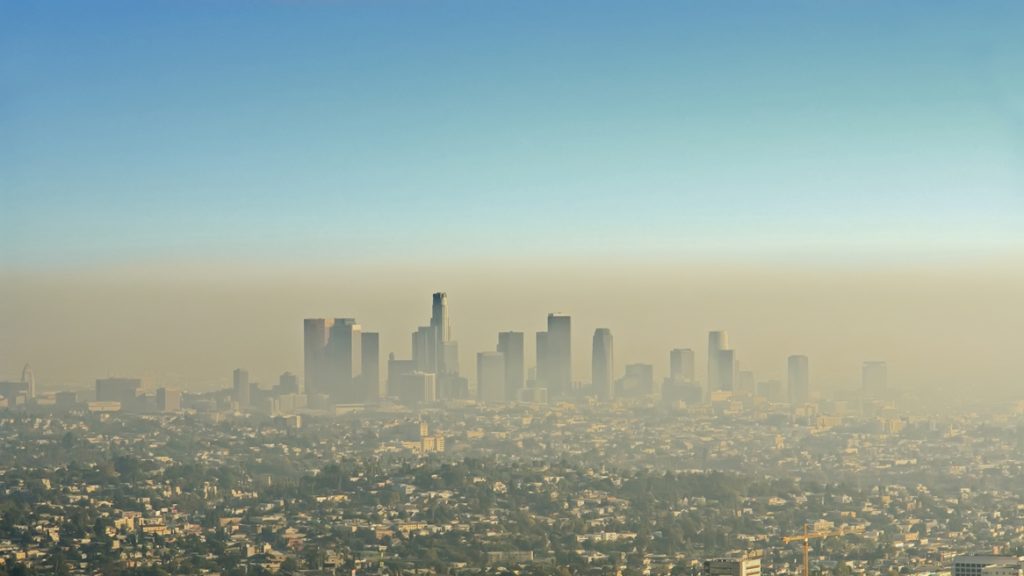 Wide shot of the downtown Los Angeles skyline bathed in smog. View from Griffith Park